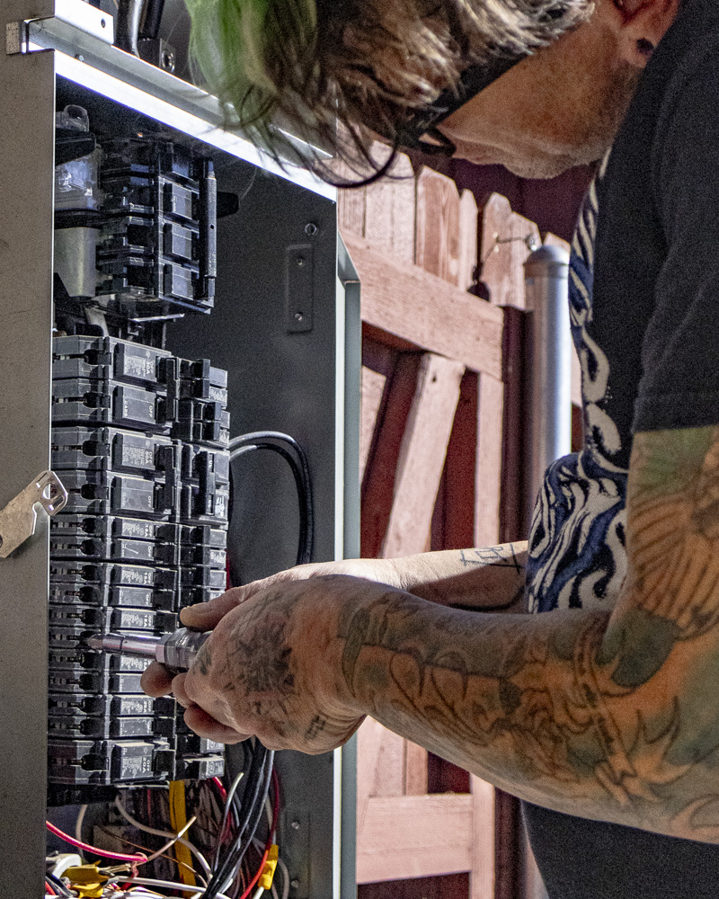 Jared — Rise Above Electric owner working a panel upgrade