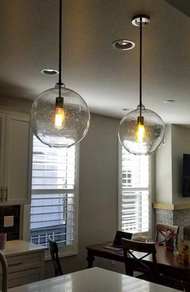Globe pendant lights over kitchen island — residential lighting Denver