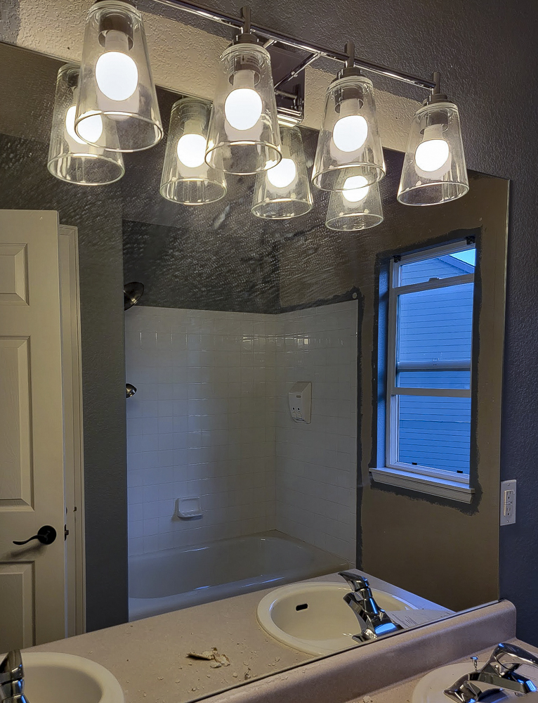 Modern bathroom lighting installation — Rise Above Electric Denver