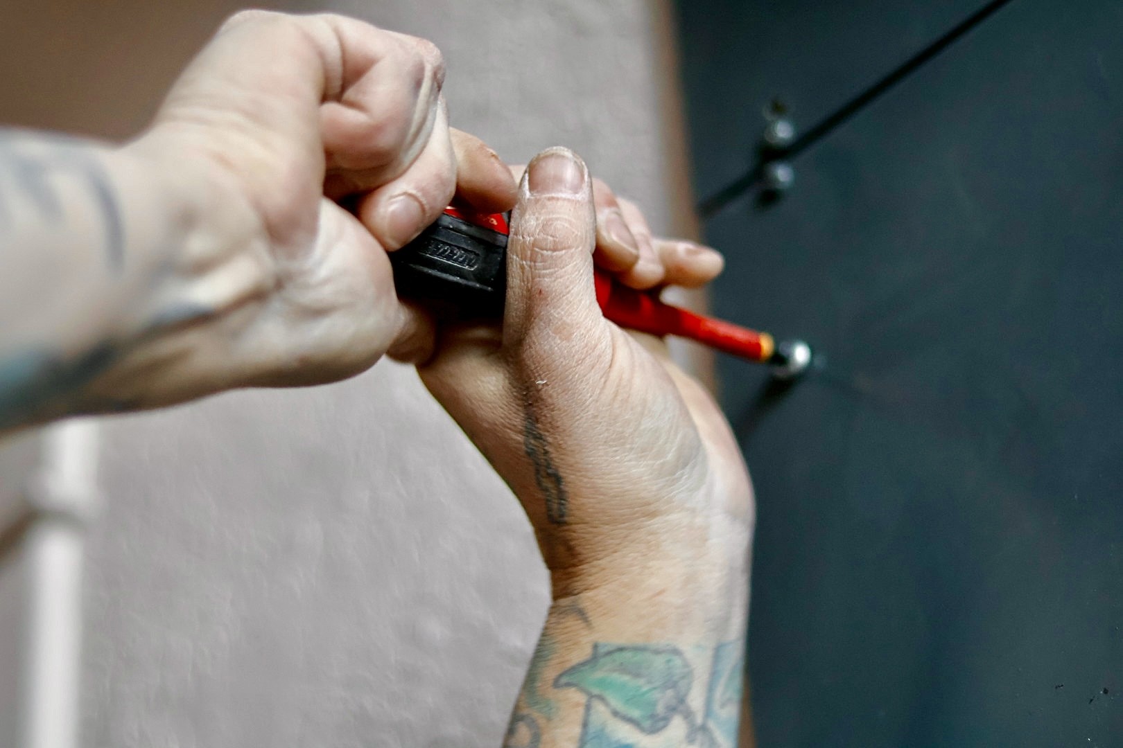 Close-up of electrician hands working with screwdriver on electrical component